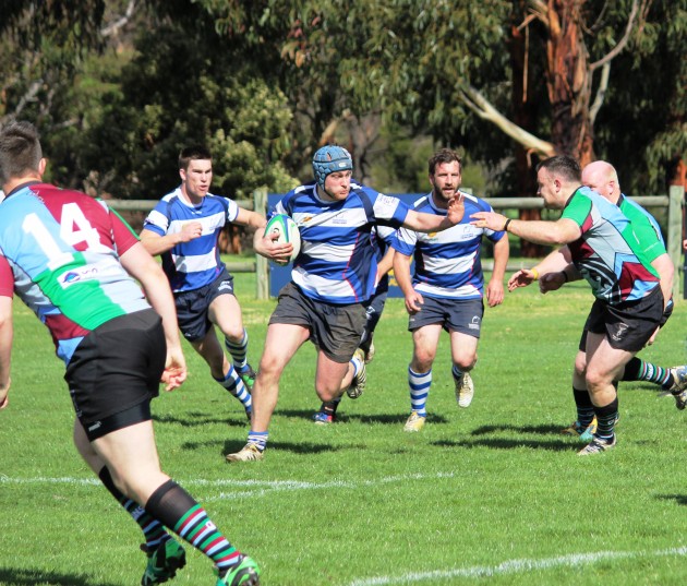 Taroona blindside flank Chris Thompson trying to work his way around Quins flanker Pat Schramm