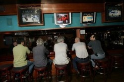 Patrons at Shula's sports bar watch tele