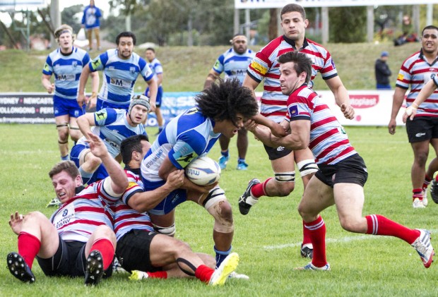 Parramatta flanker Josh Kaifa crashes into some Souths defenders _photo by Pat Dunne