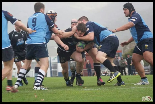 Glenorchy's Dylan Oakford drives through the AMC defence to score