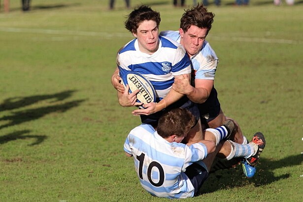 Australian Schools flyhalf, Jack McGregor, tackled by Kings' defenders