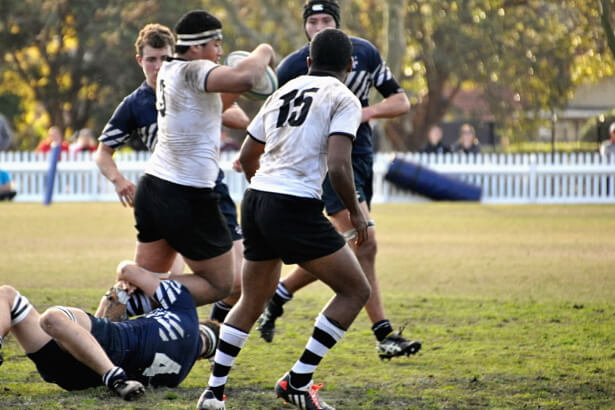 Hugh Finlay grabs a leg of Opeti Helu