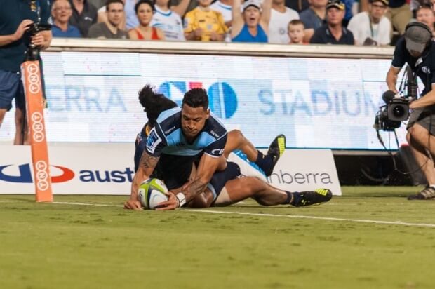 Israel Folau reaches out to score the Waratah's first try, despite the best efforts of Joe Tomane.