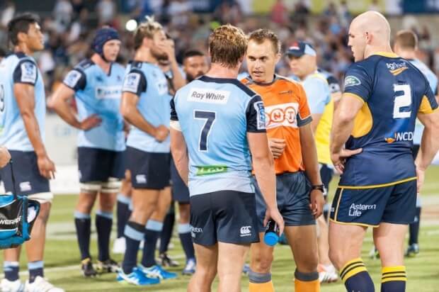 The referee talks to the captains after deciding that no sanctions were required following the all-in scuffle.