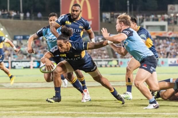 Joe Tomane reaches out towards the line to score a try for the Brumbies.