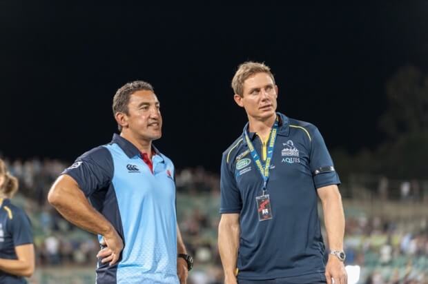 Waratahs' coach Daryl Gibson and Brumbies' coach, Steve Larkham, chat after the game.