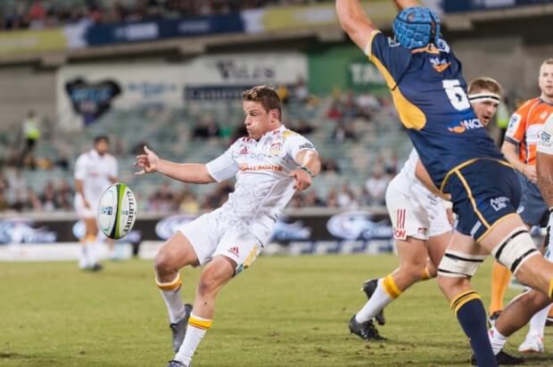 Brumbies vs Chiefs: Brad Weber box kicking the ball away before Scott Fardy blocks him.