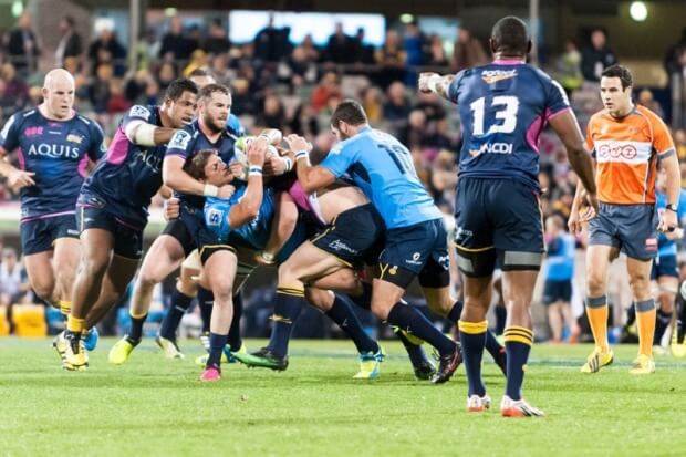 Bulls' half-back, Pet van Zyl is lifted by Coleman and David Pocock.