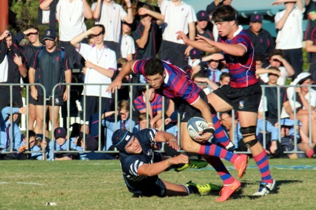 Tristan Reilly dances through a tackle