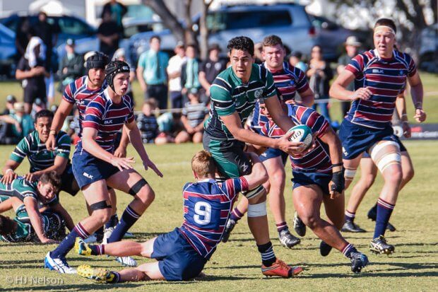 Trevor Hosea offloads in the tackle of Ted Stuart