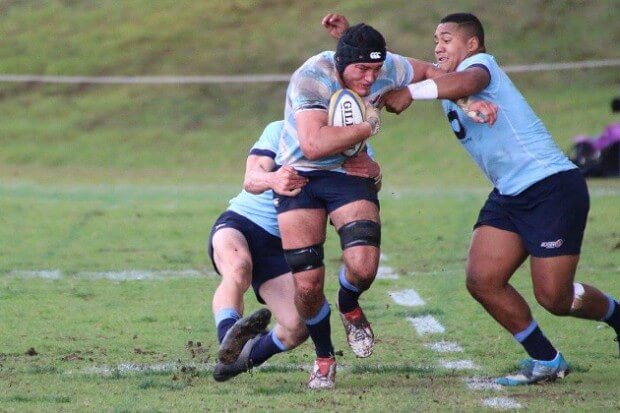 Rory Suttor attacks two tacklers