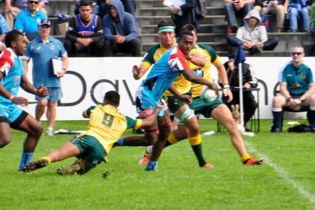 Joshua Vuta grabs a leg of Fiji skipper Lemeki  Cagialau