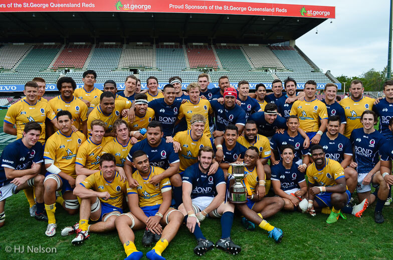 Brisbane City and Queensland Country pose for a post-match photo with the Andy Purcell Cup