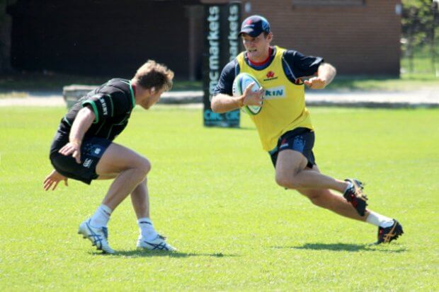 Bryce Hegarty tries a move on Cameron Clark