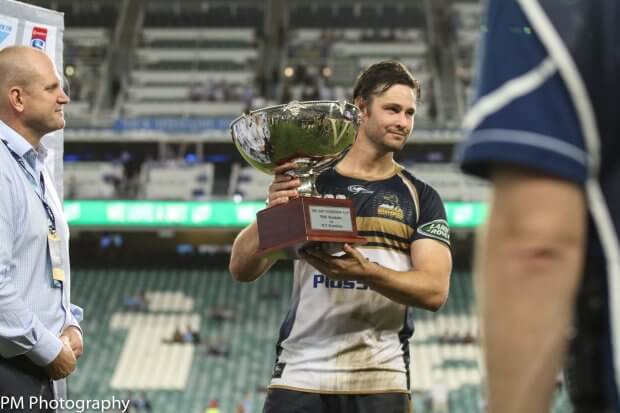 Brumby captain Sam Carter receiving the Dan Vickerman trophy.