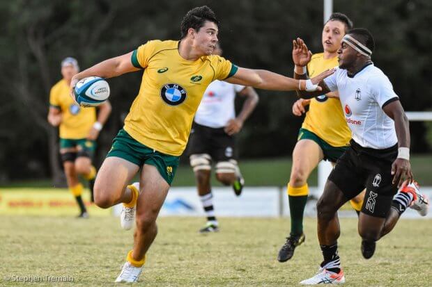 Dylan Riley attempts to fend off the Fijian tackler