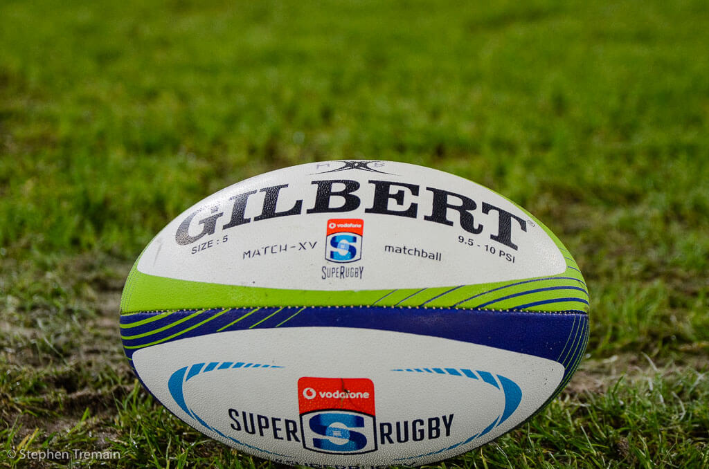 Stock Photo. Gilbert Super Rugby ball on grass.