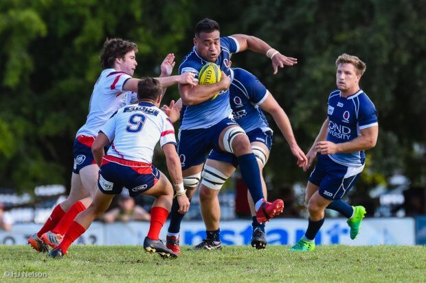 Caleb Timi crashes through a tackle