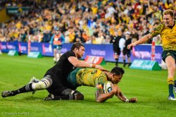 Israel Folau scores despite the tackle of Liam Squire