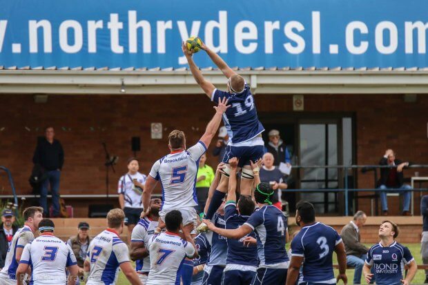 Sam Thompson reels in a lineout over Adrian Hall.