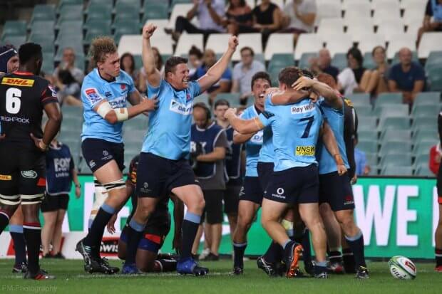 The Waratahs celebrate a Michael Hooper try.