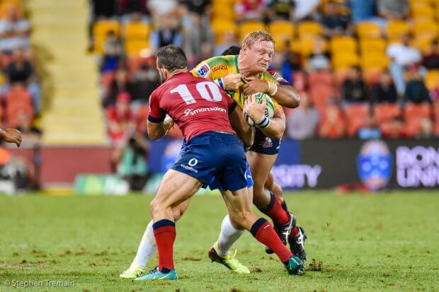 Adrian Strauss strains to break a tackle