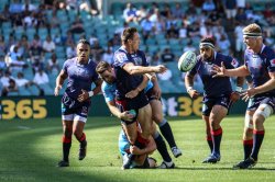 Dale Haylett-Petty offloads in a Bernard Foley tackle.