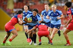 Reds tacklers bring down a NSW runner