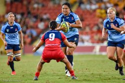 Reds tacklers bring down a NSW runner