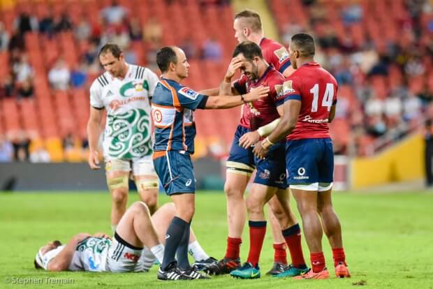 Jono Lance steadied by teammates, after a head-knock with a Chiefs player, as Jaco Pyper checks him out.