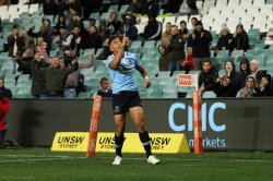 Israel Folau celebrates a try.