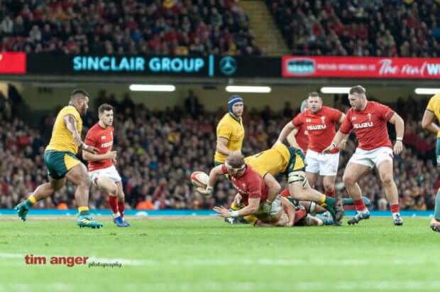 Welsh captain, Alun Wyn Jones flicks a pass back as he is tackled.